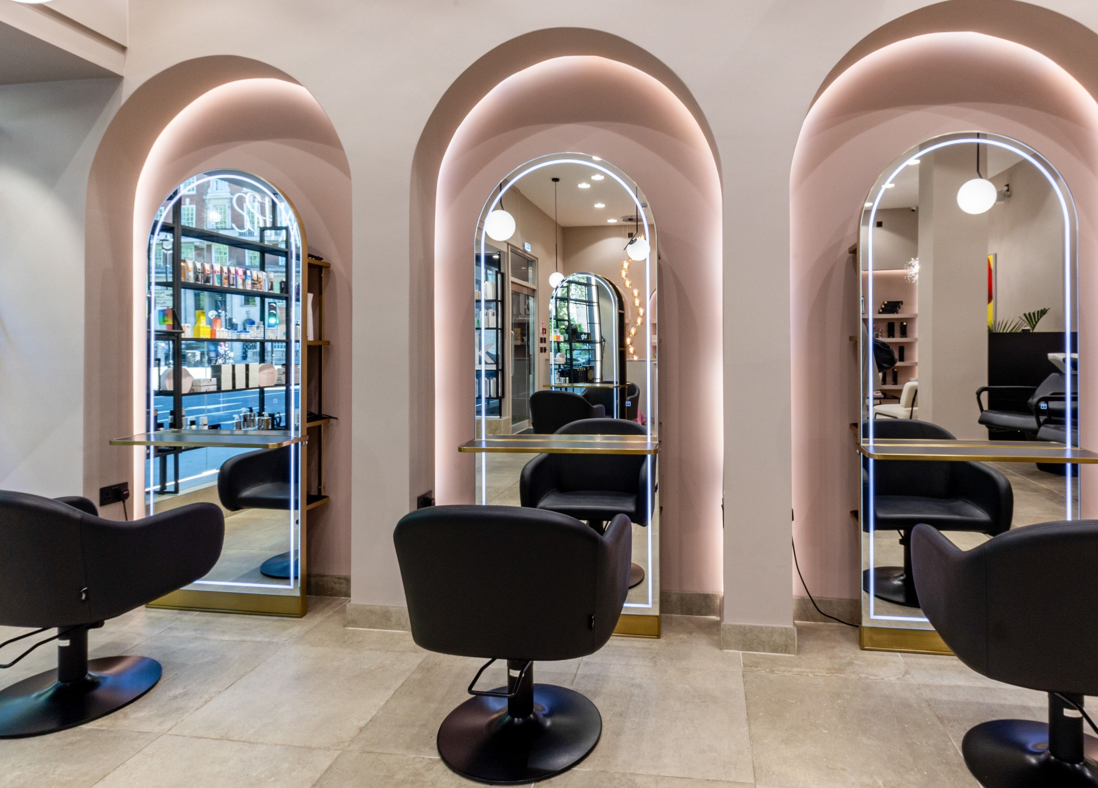 Elegant styling stations at Shadi, London, England, GB, with modern mirrors and plush seating, enhancing luxury.