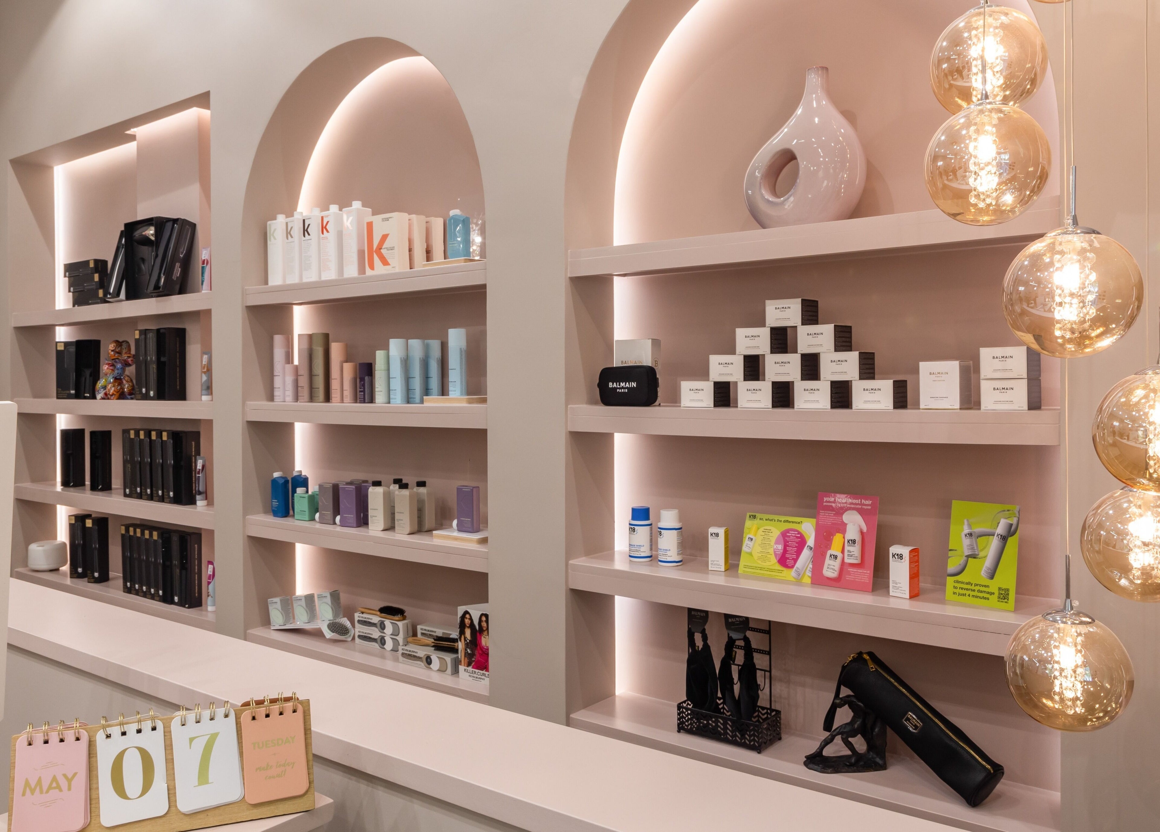Elegant shelves with beauty products at Shadi, London, England, GB, highlighting chic interior design.