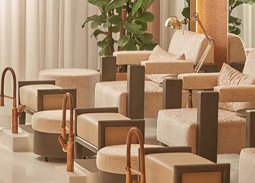 Elegant pedicure seating at Dee Salon, Riyadh, Riyadh Province, SA, with plush chairs and plants.