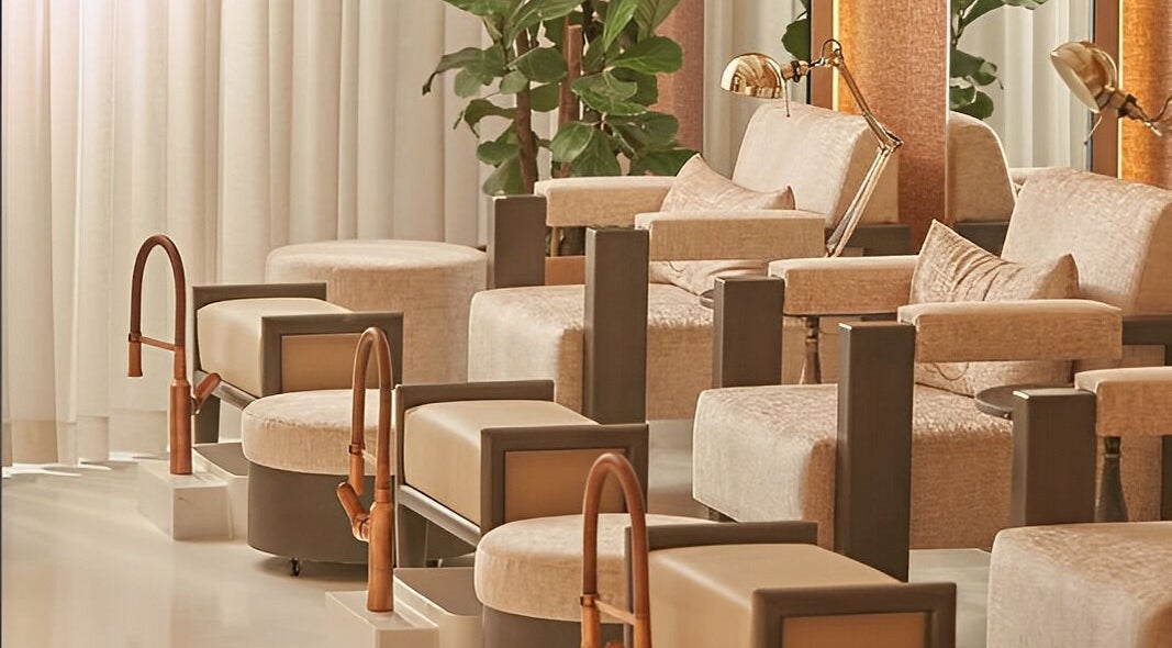 Elegant pedicure seating at Dee Salon, Riyadh, Riyadh Province, SA, with plush chairs and plants.