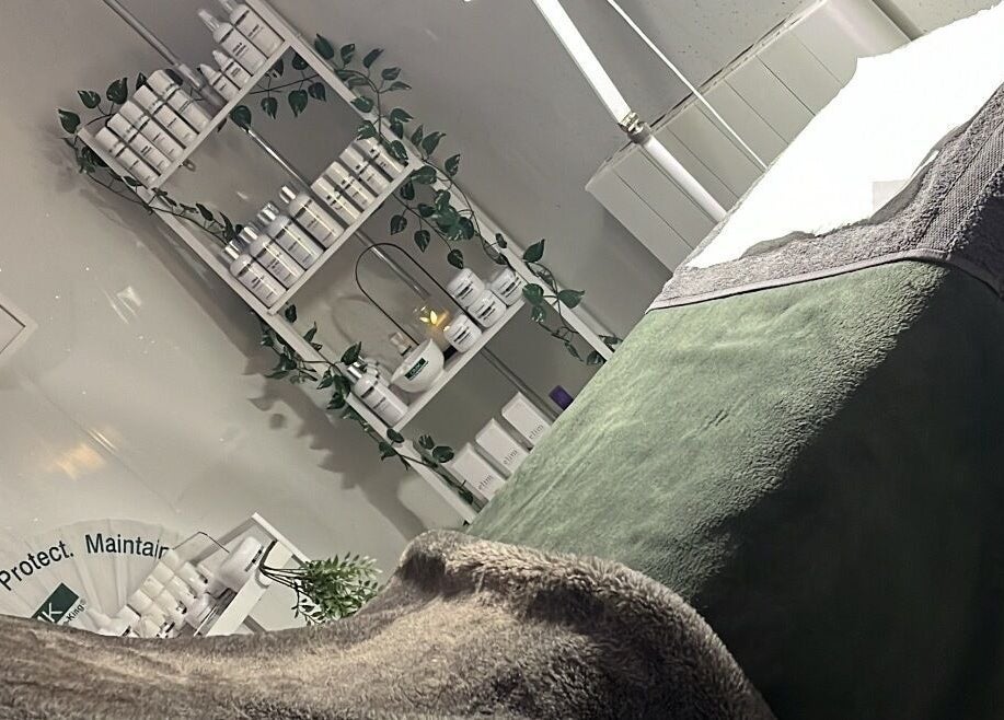 Relaxation area at Beauty and Skincare by Orla in Dunmurry, Northern Ireland. Cozy massage bed and skincare products.