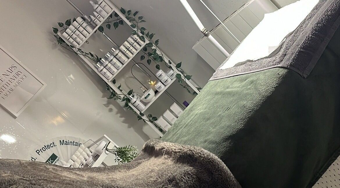 Relaxation area at Beauty and Skincare by Orla in Dunmurry, Northern Ireland. Cozy massage bed and skincare products.