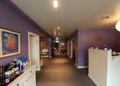Welcoming interior of Sriri Thai Massage in Melbourne, Victoria, AU with calming purple walls and elegant decor.