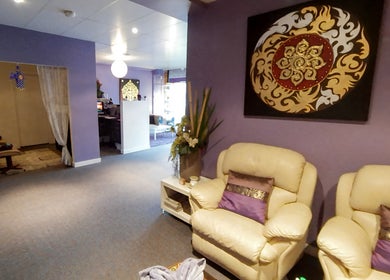 Relaxing lounge area at Sriri Thai Massage in Melbourne, Victoria, AU with plush seating and Thai decor.