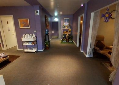 Elegant interior of Sriri Thai Massage, Melbourne, Victoria, AU with calming lavender decor and cozy seating.