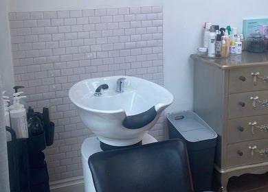 Chic wash station at Andria Loizou Hair in London, England, GB, featuring modern basin and stylish products.