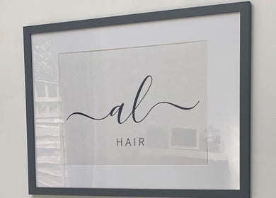 Framed Andria Loizou Hair logo on wall at salon in London, England, GB.