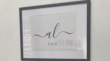 Framed Andria Loizou Hair logo on wall at salon in London, England, GB.