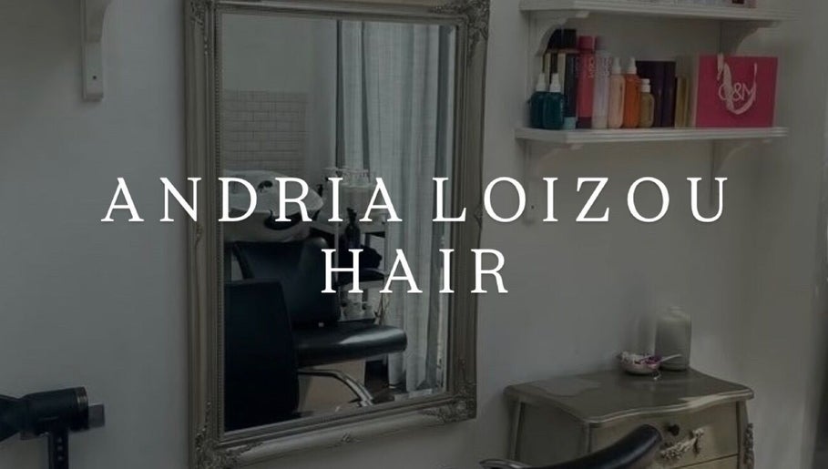 Chic interior of Andria Loizou Hair in London, England, GB, showcasing a vintage mirror and stylish shelves.