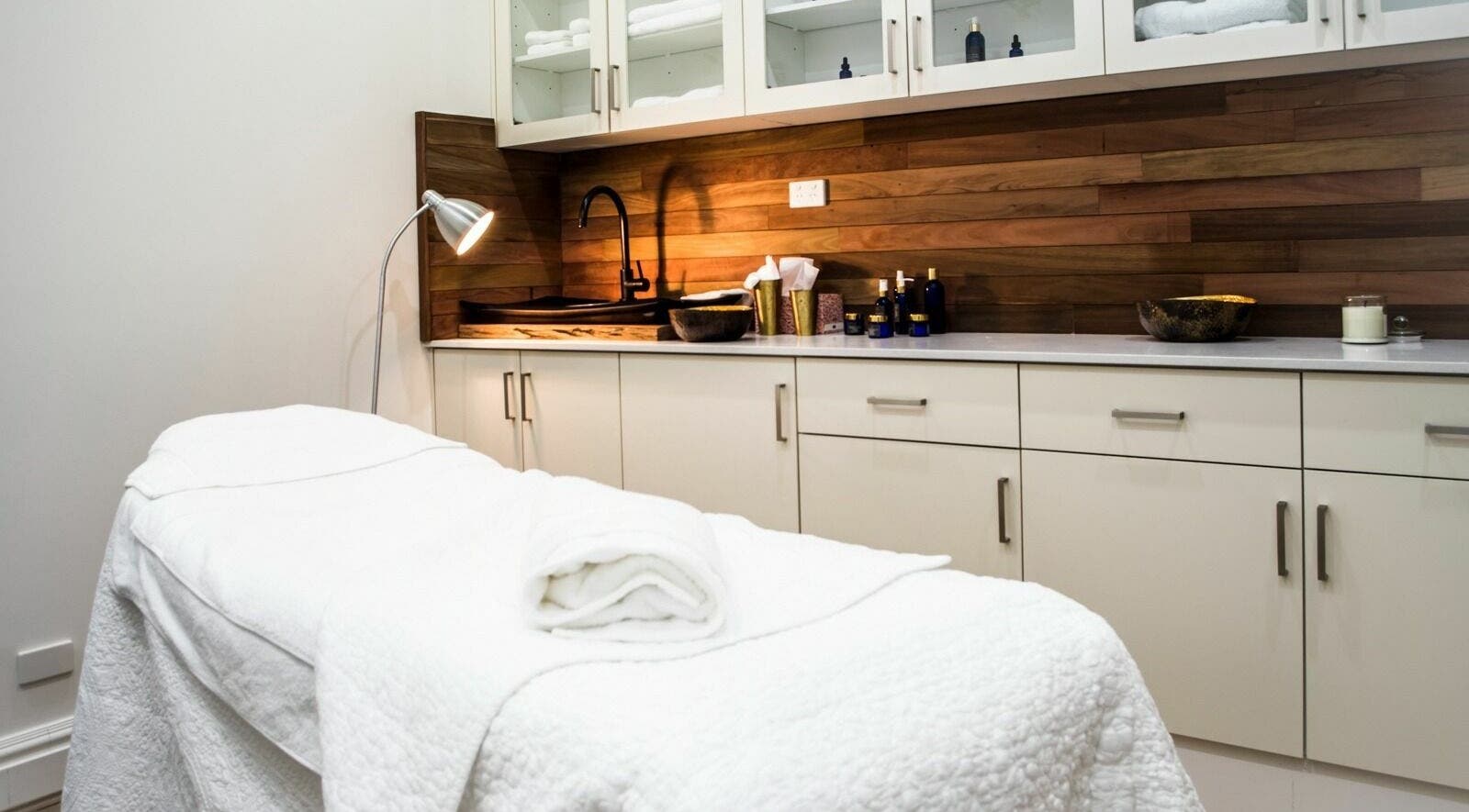 Relaxing treatment room at Skin Body Health Clinic, Woollahra, New South Wales, AU with plush bed and warm lighting.