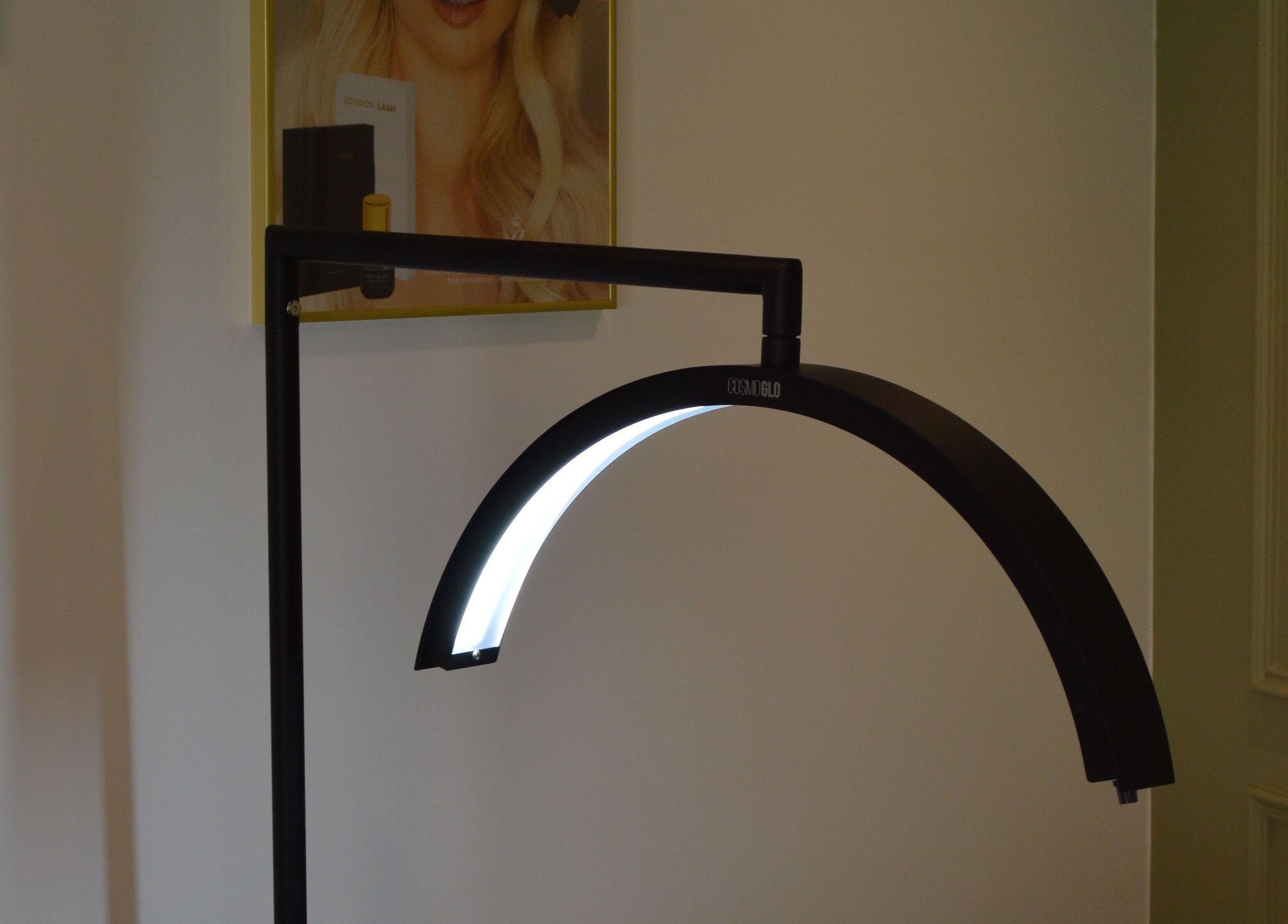 Modern lamp illuminates poster at Refine by Abbie Baker, Wouldham, GB, creating a sophisticated ambiance.