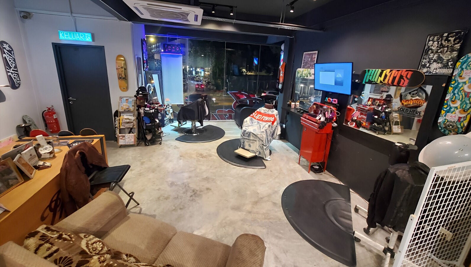 Interior of Ace Studio Barbershop & Salon in Kuala Lumpur, featuring stylish decor and barber chairs.