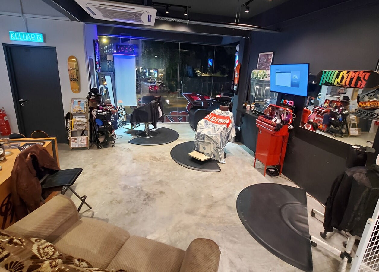Interior of Ace Studio Barbershop & Salon in Kuala Lumpur, featuring stylish decor and barber chairs.