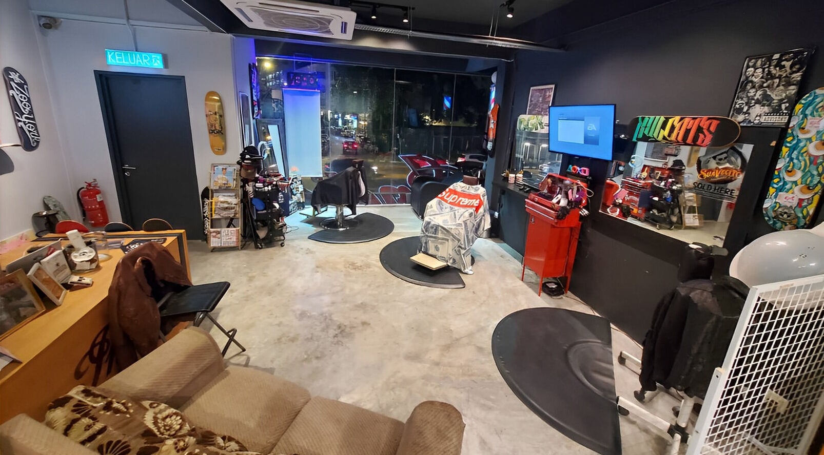 Interior of Ace Studio Barbershop & Salon in Kuala Lumpur, featuring stylish decor and barber chairs.