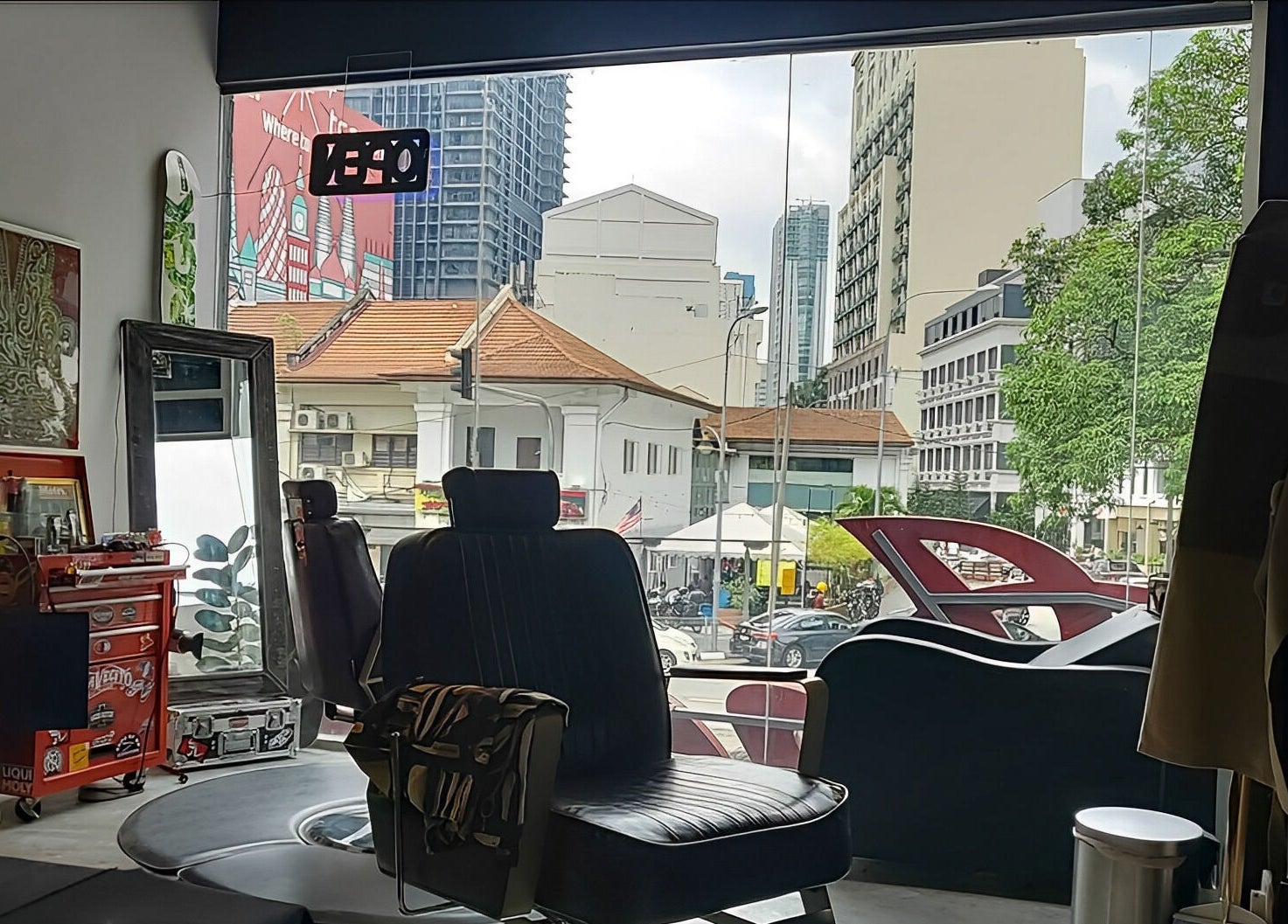 Interior view of Ace Studio Barbershop & Salon in Kuala Lumpur, MY, with a barber chair near the window.