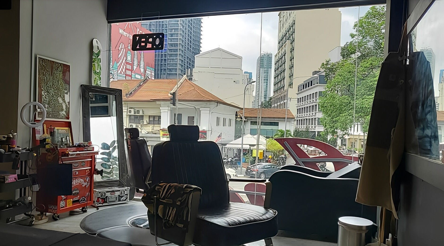 Interior view of Ace Studio Barbershop & Salon in Kuala Lumpur, MY, with a barber chair near the window.