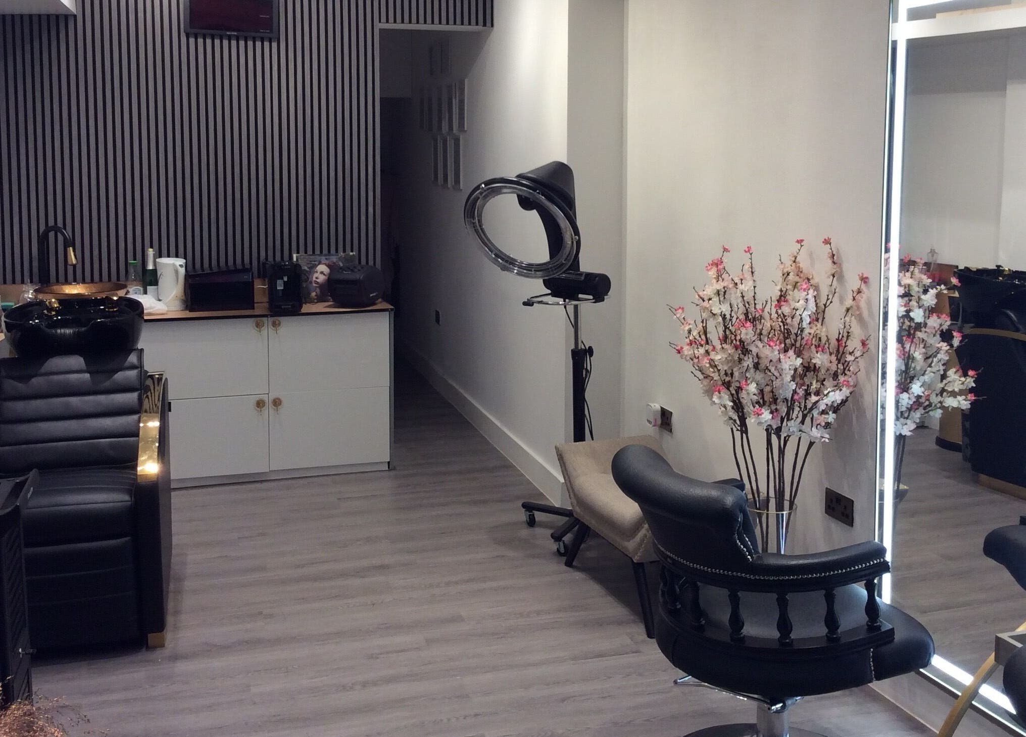 Elegant salon setup at Just Gorgeous by Paty Silva, London, England, GB. Modern decor with black leather chairs.