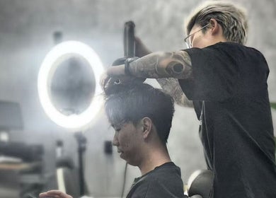 Barber styling hair at Rex‘s Barbershop, Auckland, Auckland, NZ.