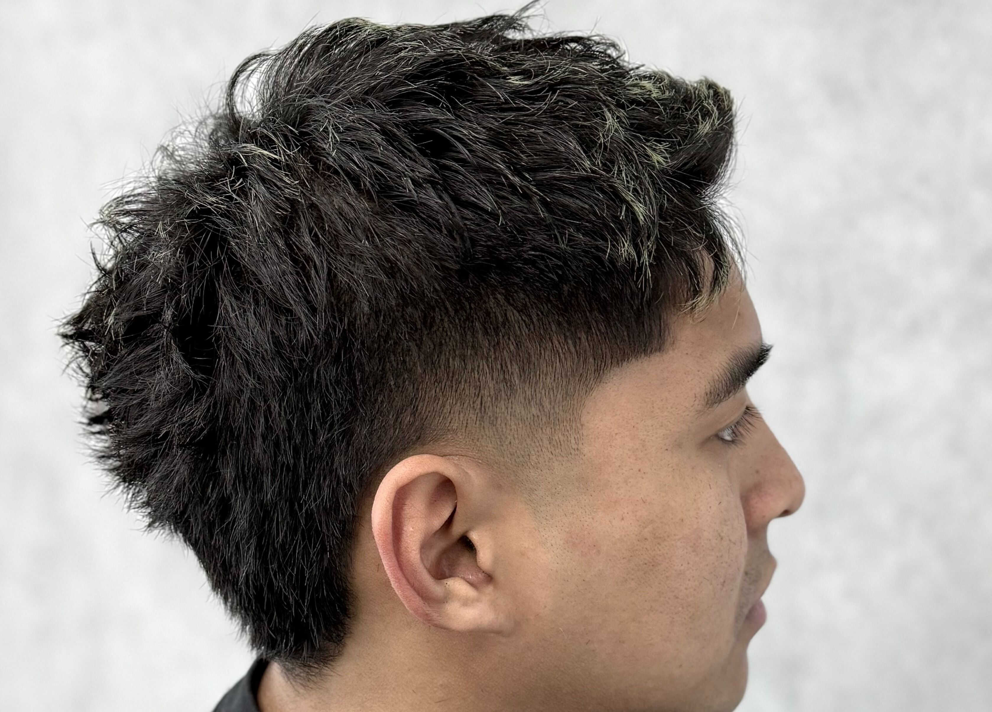 Stylish haircut at 9t3 Barber Studio in Auckland, NZ, featuring a modern fade.