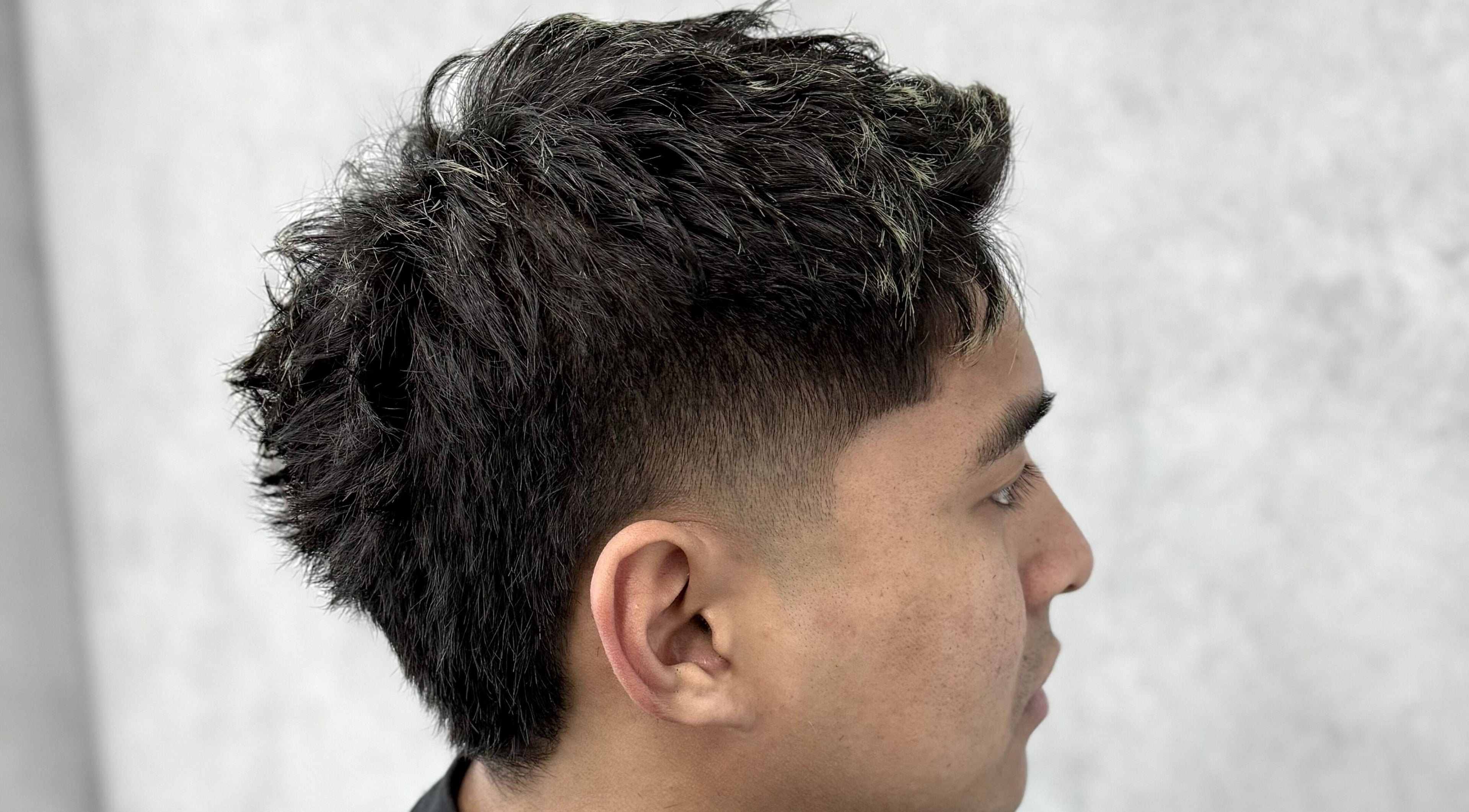 Stylish haircut at 9t3 Barber Studio in Auckland, NZ, featuring a modern fade.