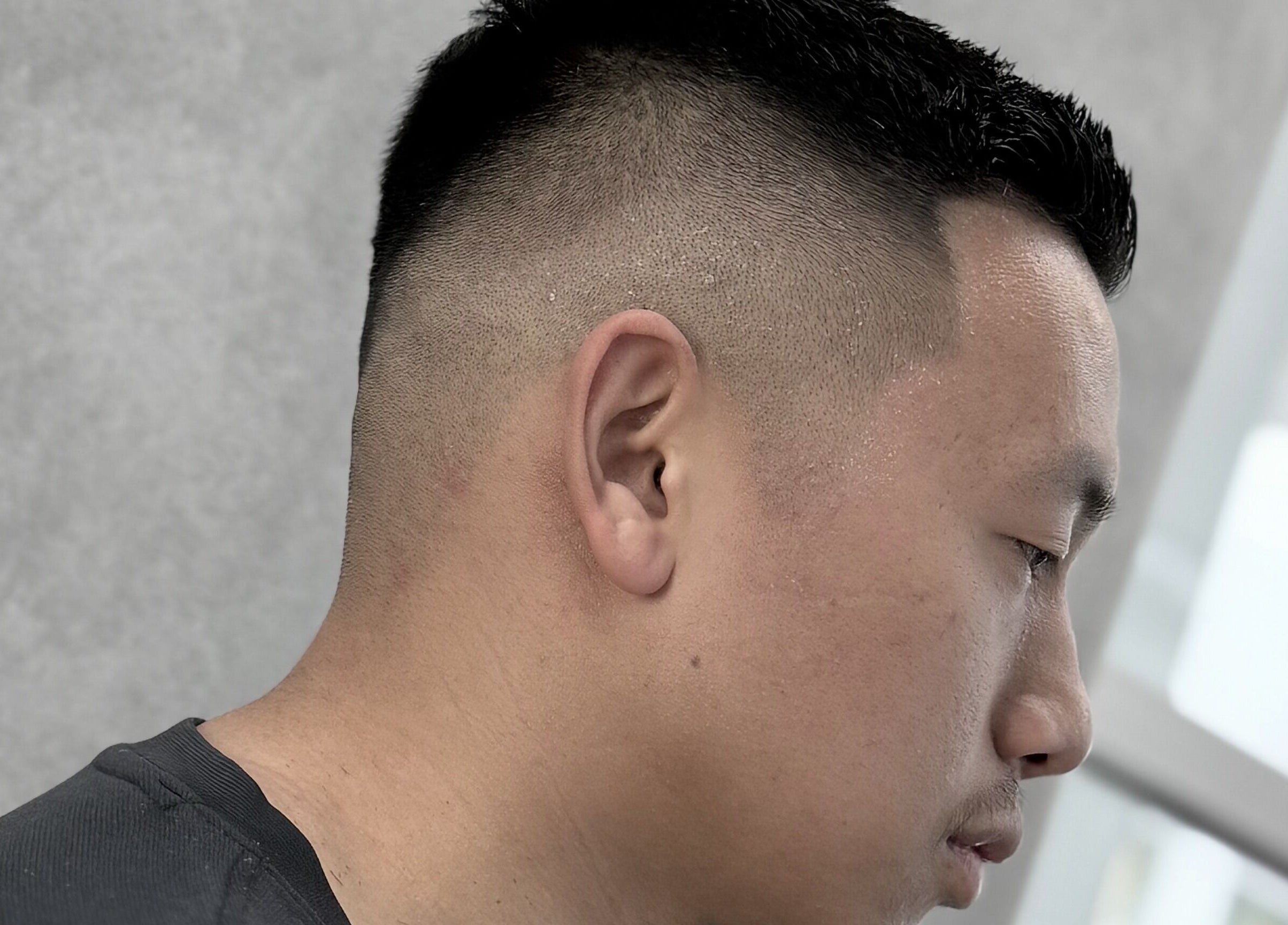 Close-up of a sharp fade haircut at 9t3 Barber Studio, Auckland, Auckland, NZ, showcasing precision styling.