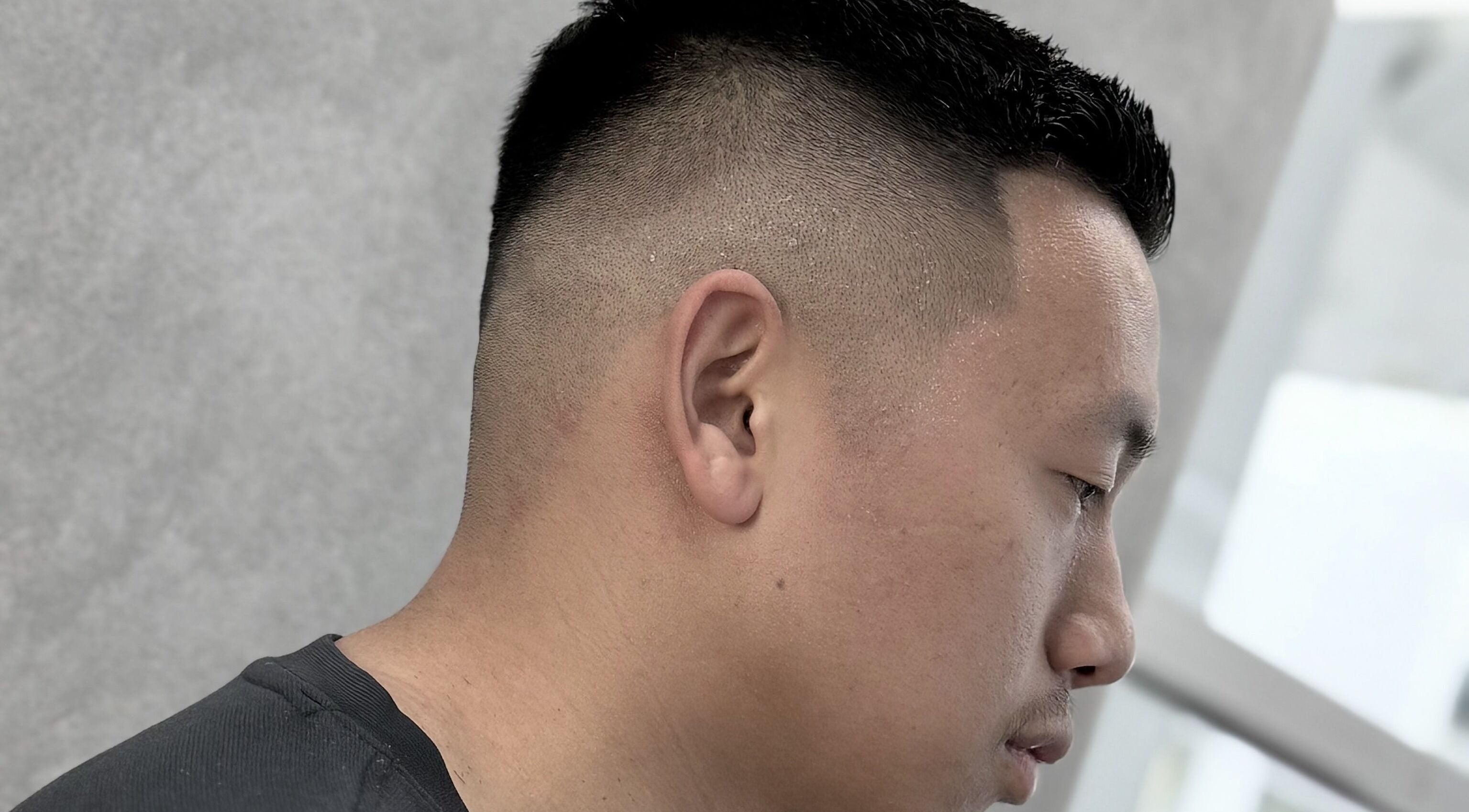 Close-up of a sharp fade haircut at 9t3 Barber Studio, Auckland, Auckland, NZ, showcasing precision styling.