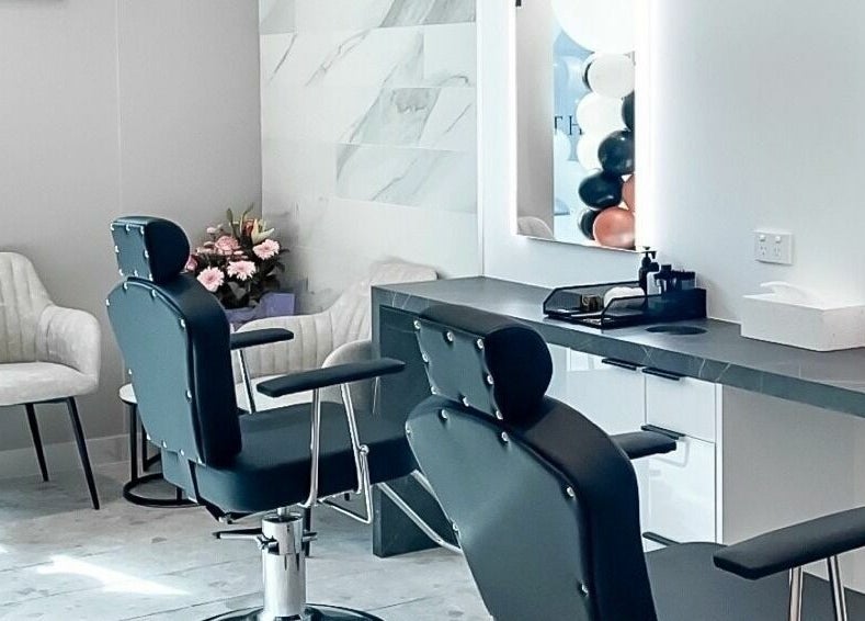 Modern salon interior at Thread'In Shape - Caddens in Caddens, New South Wales, AU, featuring stylish chairs and mirrors.