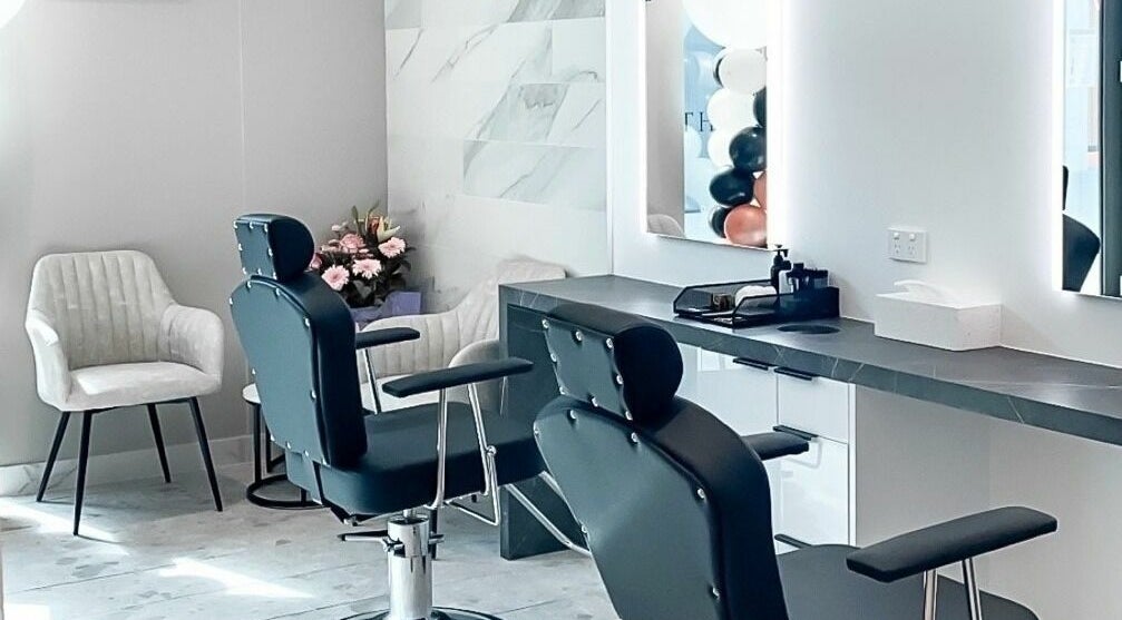 Modern salon interior at Thread'In Shape - Caddens in Caddens, New South Wales, AU, featuring stylish chairs and mirrors.