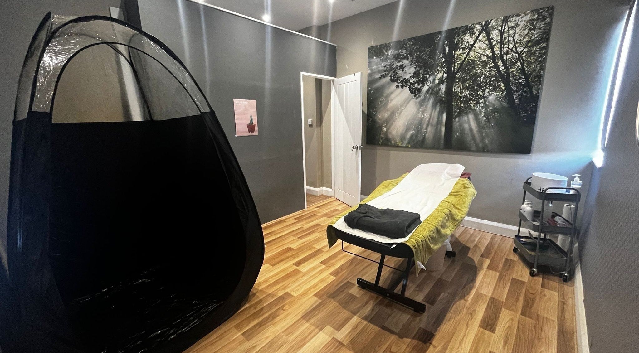 Cozy spa room at Monria Hair and Beauty Salon, St. Albans, England, GB, showcasing a treatment bed and serene decor.