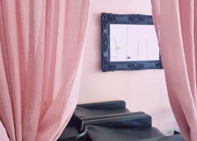 Elegant salon with pink curtains at Roots Color Studio, Bloemfontein, Free State, ZA. Perfect for relaxation.