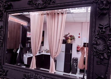 Elegant mirror reflection at Roots Color Studio Hairdressing in Bloemfontein, Free State, ZA, showcasing decor and atmosphere.