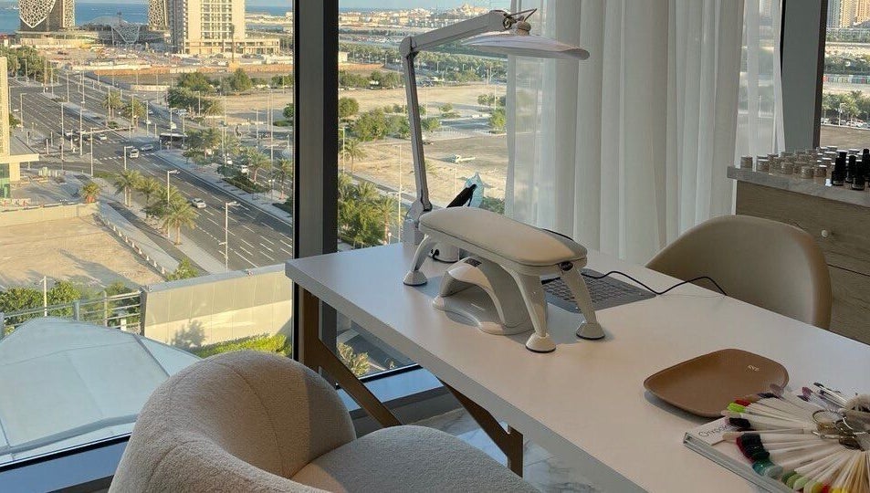 Bright workspace view at Re:Vision Studio, لوسيل, بلدية الضعاين, QA with cityscape outside.