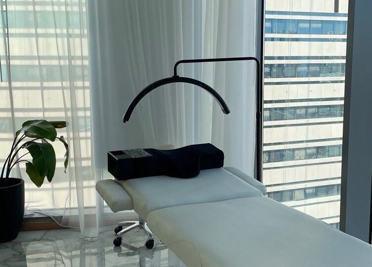 Spa treatment room at Re:Vision Studio, لوسيل, بلدية الضعاين, QA, featuring a massage table and plant.