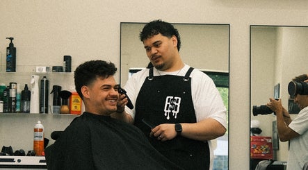 Barber styling a client's hair at Reezy at Blurry Boy$ Club, Pleasant Grove, Utah, US.