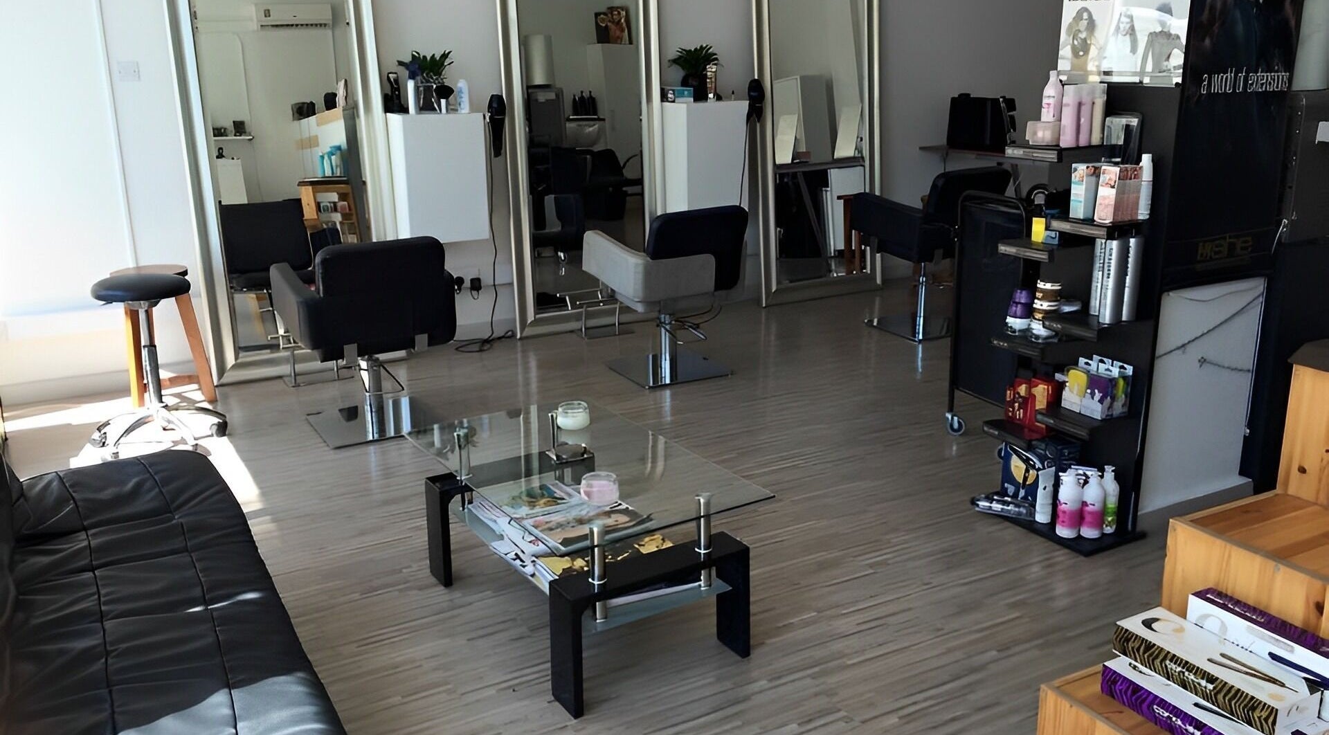 Spacious interior of NG HAIR BOUTIQUE in Limassol, Limassol, CY showcasing styling stations and product displays.