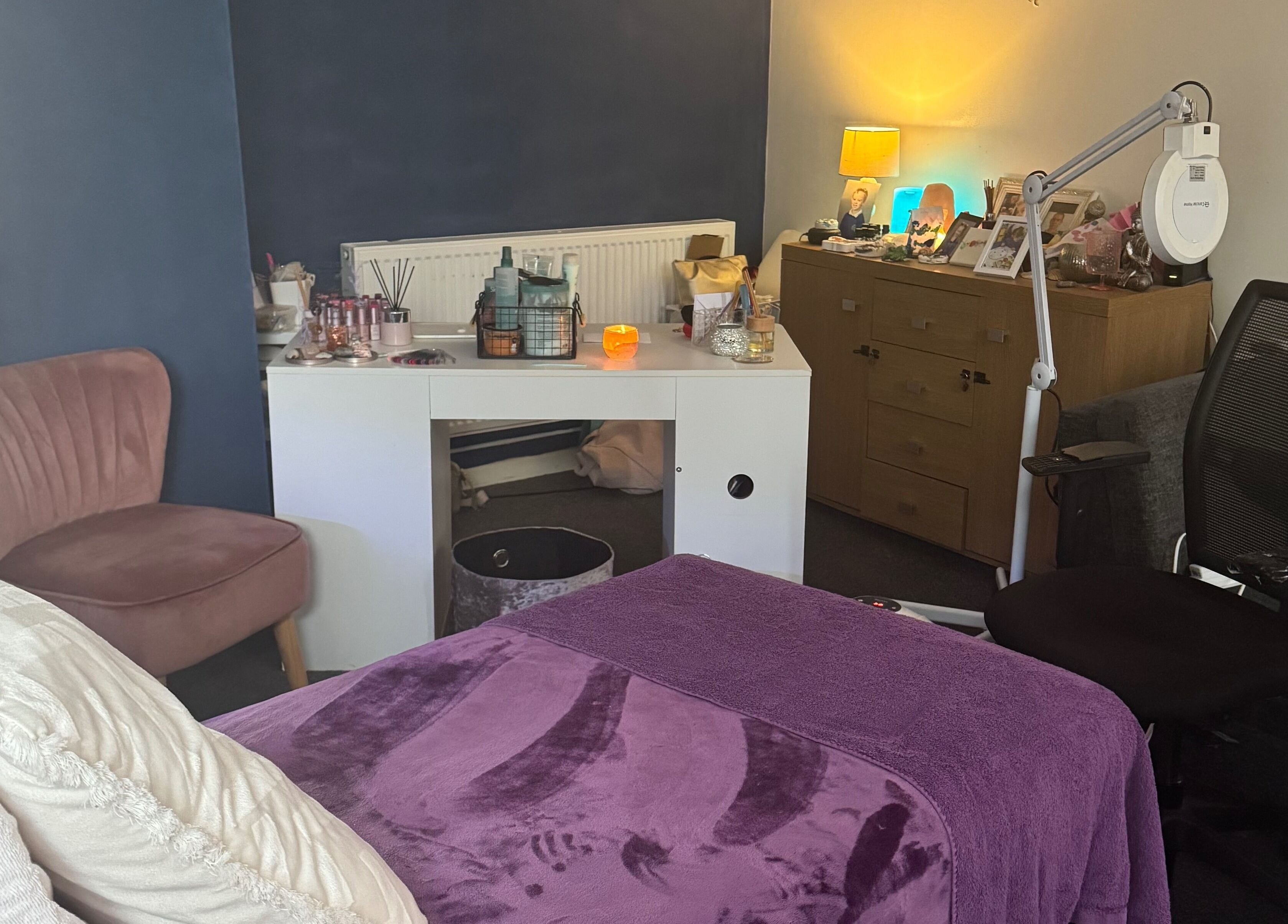 Cozy Beautylicious treatment room in Poole, England, GB with plush bed and ambient lighting.