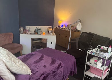 Cozy wellness treatment room at Beautylicious, Poole, England, GB, featuring massage table and beauty equipment.