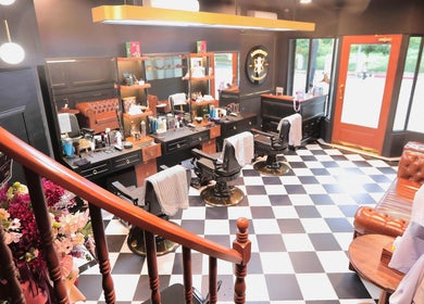 Interior of Barberlogy Barbershop - Shinsawpu in Yangon, MM, featuring stylish chairs and classic barber decor.