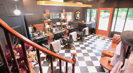 Interior of Barberlogy Barbershop - Shinsawpu in Yangon, MM, featuring stylish chairs and classic barber decor.