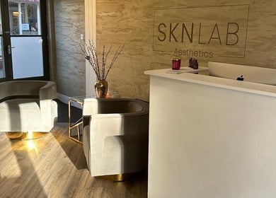 Reception area at Amy Salmon Aesthetics in Ware, England, GB, showcasing modern design and luxury seating.