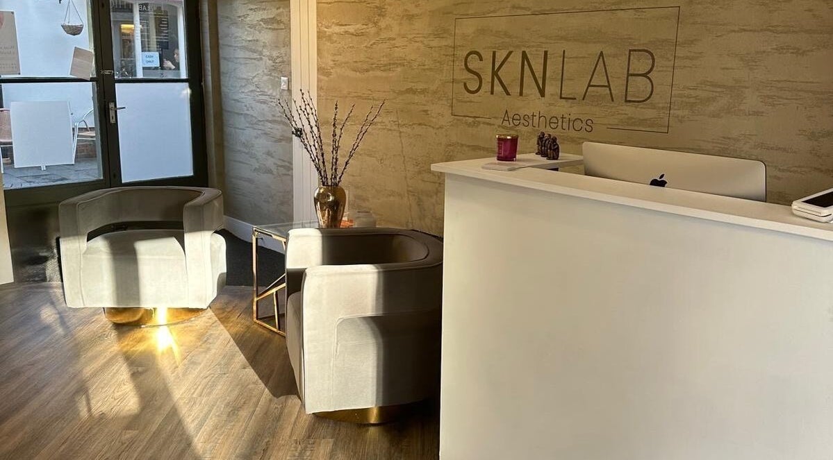 Reception area at Amy Salmon Aesthetics in Ware, England, GB, showcasing modern design and luxury seating.