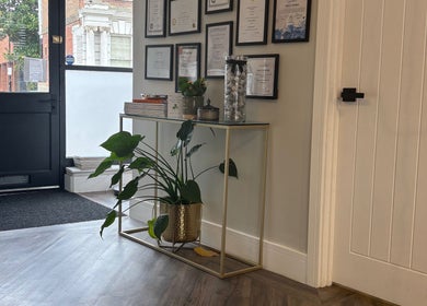 Stylish entry with plant and diplomas at Amy Salmon Aesthetics, Ware, England, GB.