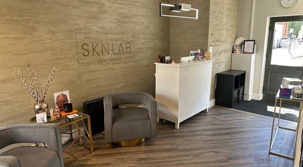 Elegant reception at Amy Salmon Aesthetics, Ware, England, GB, featuring contemporary decor and seating.