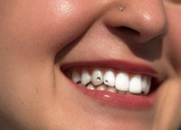 Close-up of a smiling woman with tooth gems at Vi.LashYou Westmount in London, Ontario, CA.