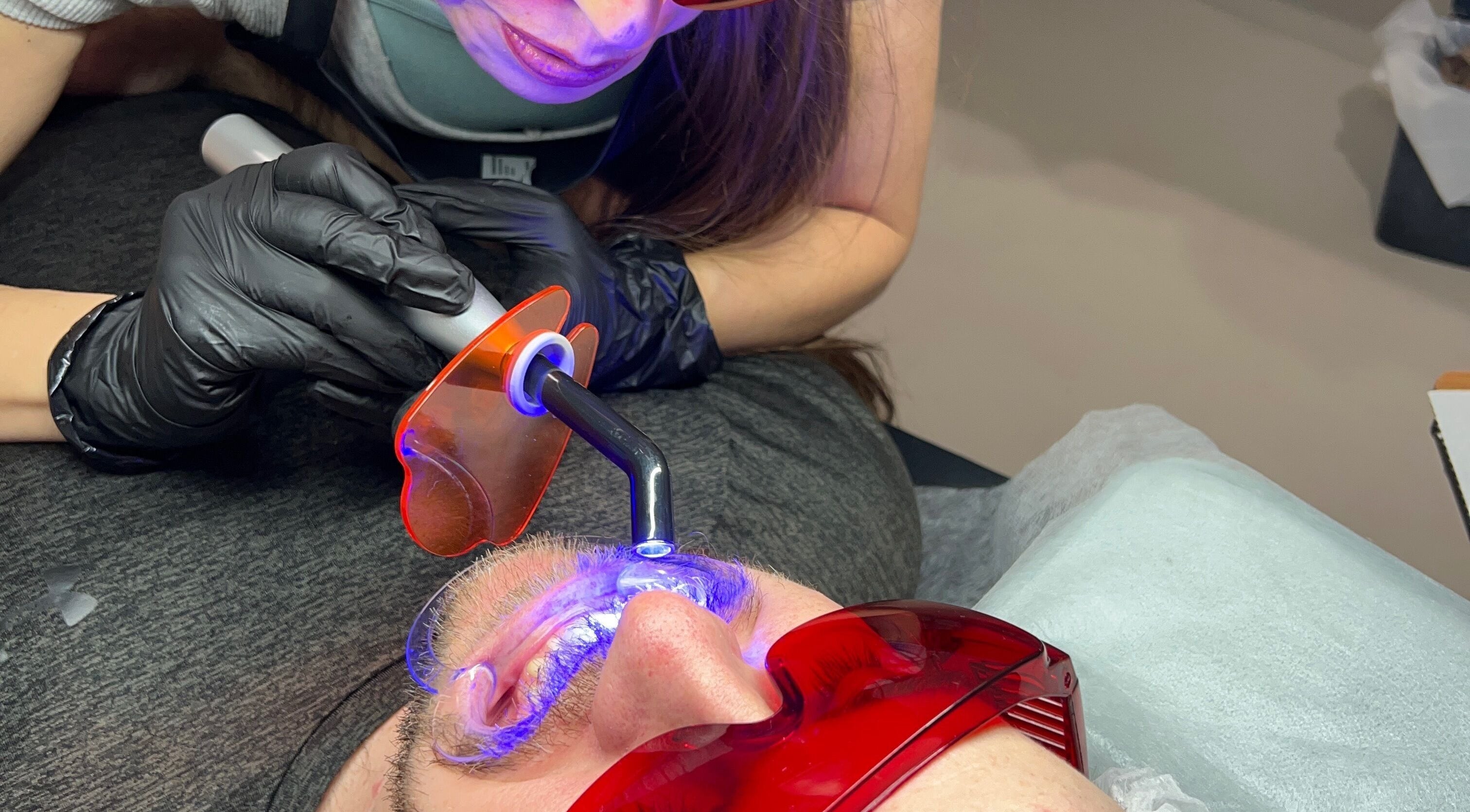 Expert performing eye light therapy at Vi.LashYou Westmount, London, Ontario, CA for radiant results.