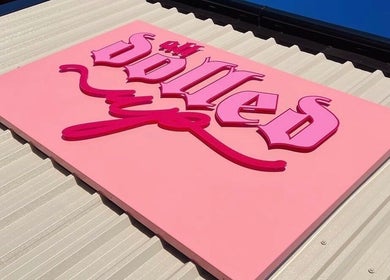 Bright pink venue sign for Gels by Renata in Middlesbrough, England, GB on a sunny day.