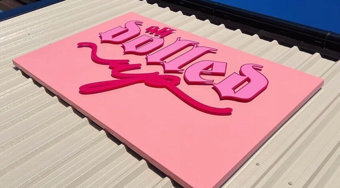 Bright pink venue sign for Gels by Renata in Middlesbrough, England, GB on a sunny day.