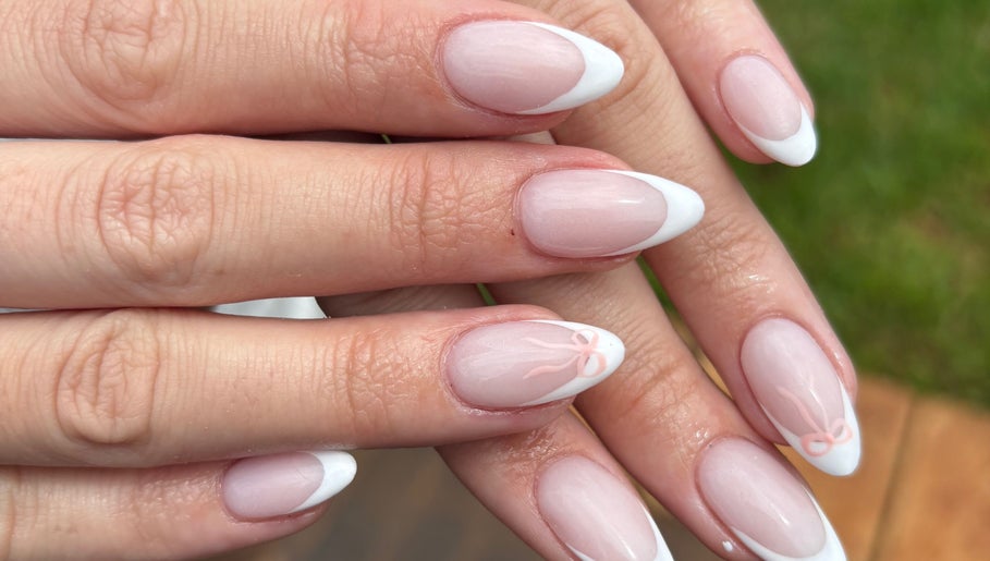 Elegant French manicure at Nails by Shanté, Pretoria, Gauteng, ZA showcasing white tips and subtle bow design.