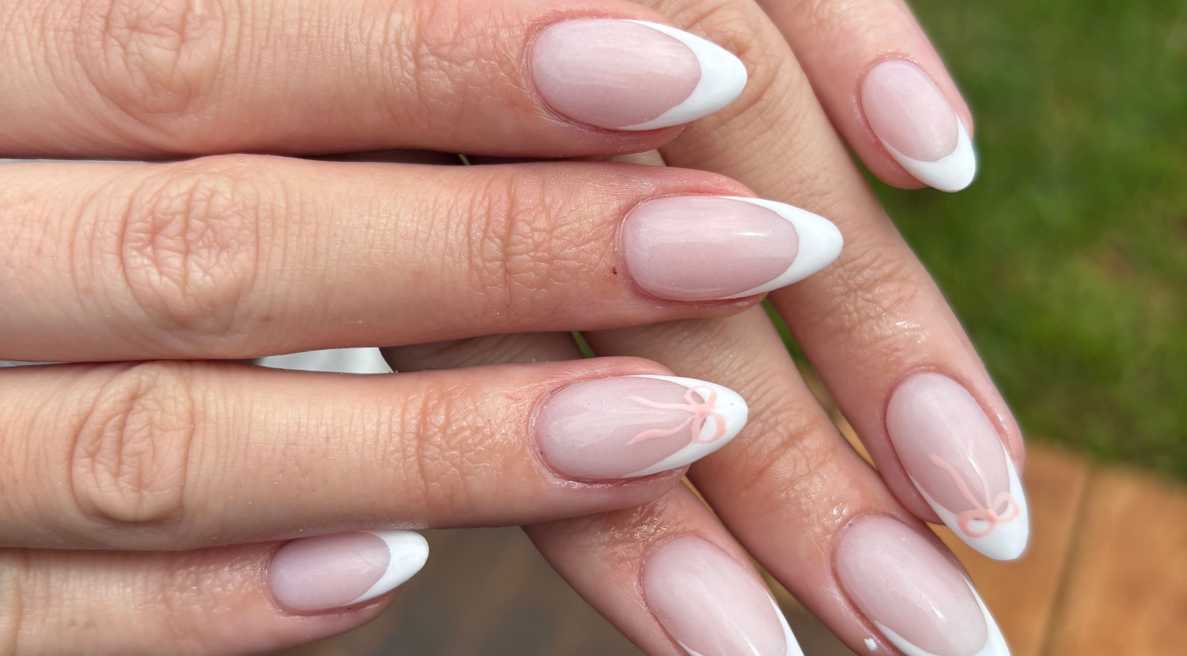 Elegant French manicure at Nails by Shanté, Pretoria, Gauteng, ZA showcasing white tips and subtle bow design.