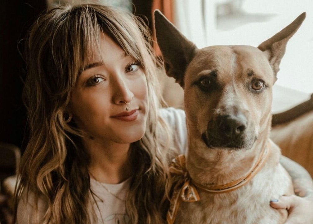 A person with a dog at Third Hand Salon, Rock Island, Illinois, US, showcasing a welcoming atmosphere.